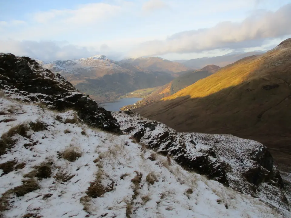 Arrochar and the head of Loch Long seen from a snowy hillside above the village