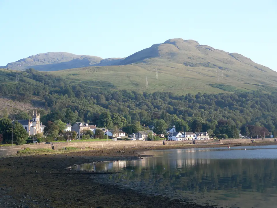 Arrochar village on the shore of the loch, with a large hill behind it