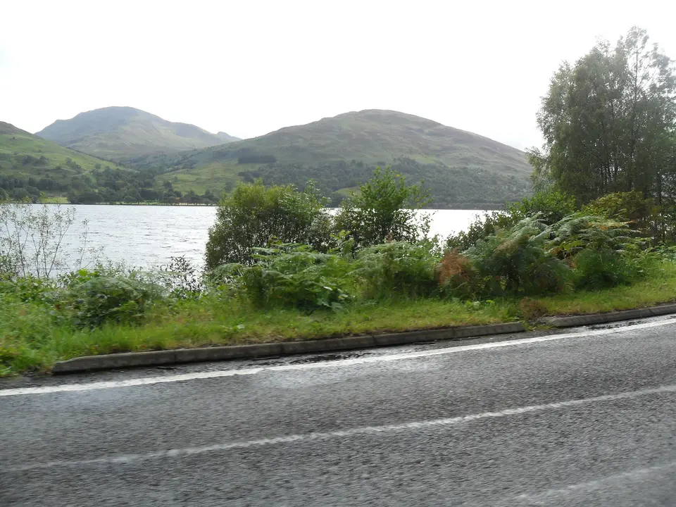 Ben Vorlich rising above the shore of Loch Earn seen from the road