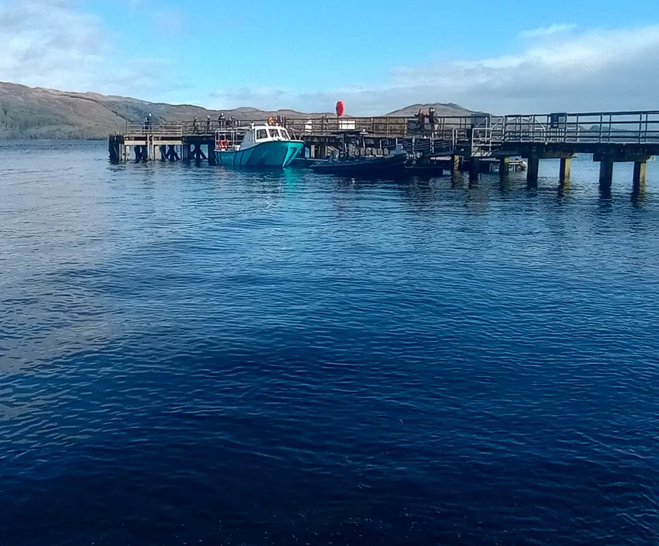 Boats moored beside Luss Pier on Loch Lomond