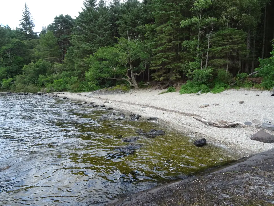 A sand and pebble beach in the Lochan Maol Dhuinne camping permit area