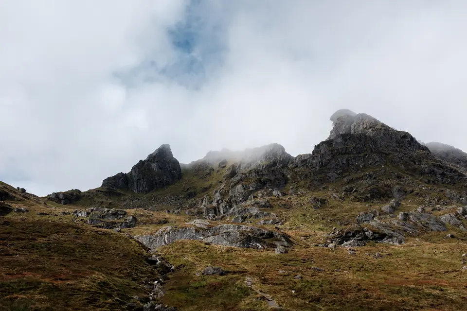 The Cobbler's rocky summit ridge with cloud drifting between the peaks