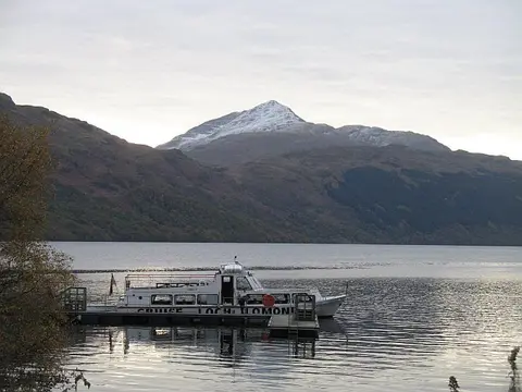 A Loch Lomond cruise boat at Inveruglas with Ben Lomond behind