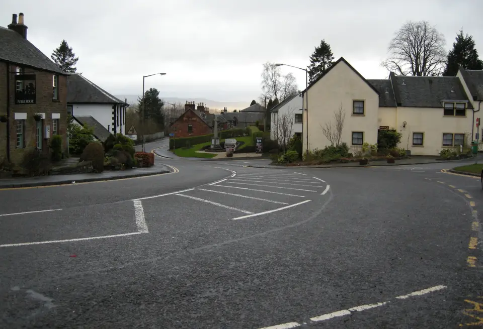 The centre of Drymen village with pubs and shops around the square