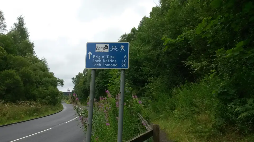 A Great Trossachs Path waymarker beside the A821 near Kilmahog
