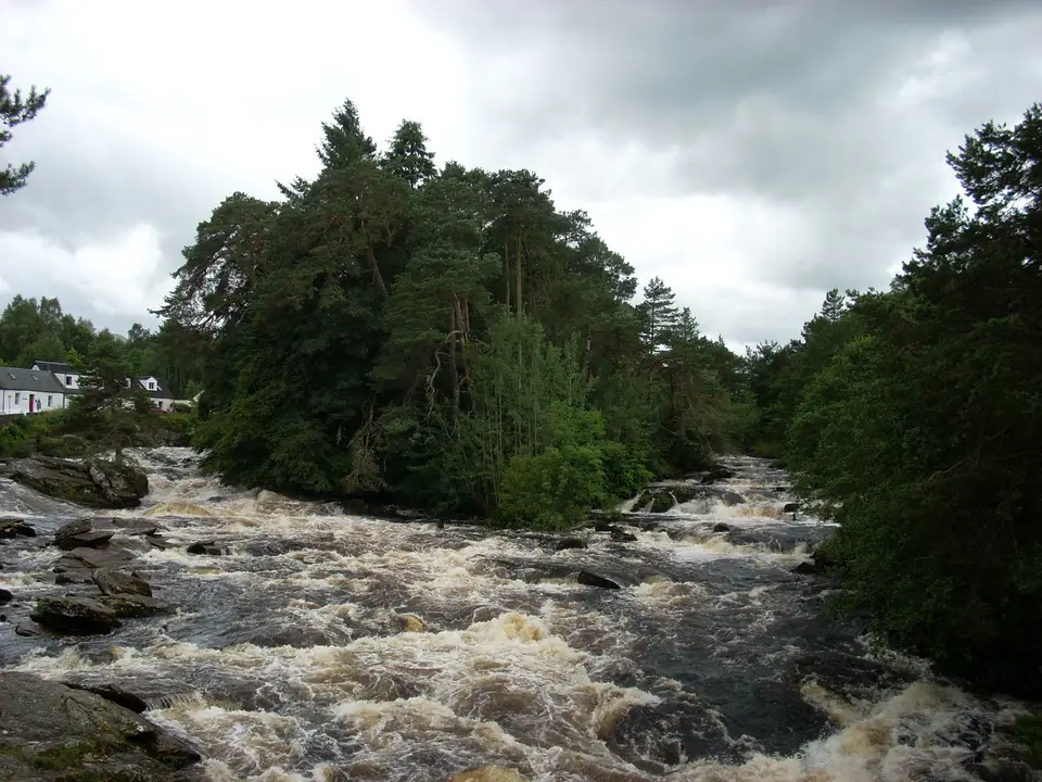 Rapids on the River Dochart at Killin, with a wooded island and houses on the far bank