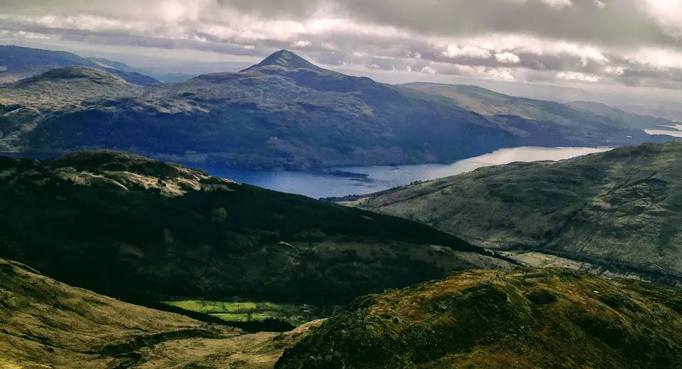 Ben Lomond rising above Loch Lomond seen from Beinn Narnain in evening light