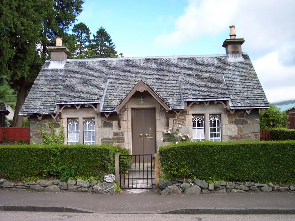A slate-roofed stone cottage with a garden in Luss