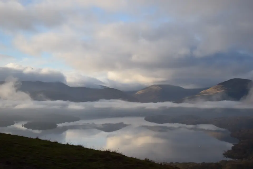 Mist lying over Loch Lomond and its islands, seen from a hillside above the water